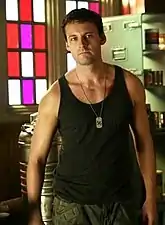 Zod in the TV program Smallville, wearing a black athletic shirt, camouflage pants and Kryptonian dog-tags