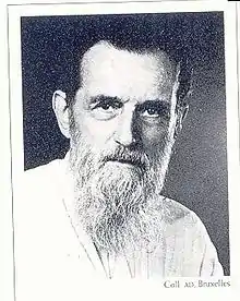 Black and white profile photograph of an old man in white beard and dark hair.