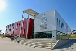 Building exterior clad in red and silver siding