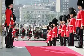 The Canadian Grenadier Guards' full dress headgear is a bearskin cap with a white plume.