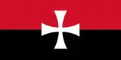 The first flag of the Canadian Nationalist Party. It is a red (top) and black (bottom) bicolour charged with a white Templar cross in the centre.