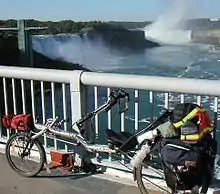 Recumbent bicycle with bottle cages mounted behind the seat back