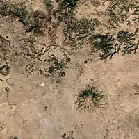 A satellite image of the volcano (center) and the surrounding area