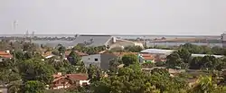 Long shot of a city located on water with a building saying "Cargill" on its roof