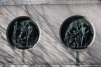 Side of the statue with reliefs representing Science and History