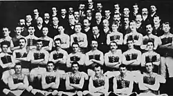 A group of men pose for a team photograph.