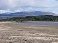 Carradale Beach with the snow-capped hills of the Isle of Arran in the distance.