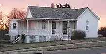 One-story frame house with wraparound front porch