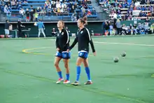 Solaun (right) with Reign FC teammate, Carson Pickett, 2016.