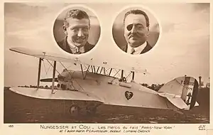 Faded brown postcard with a photograph of a white biplane. Two oval cameo pictures are above the aircraft, showing the faces of two men. On the left, is a clean-shaven healthy-looking man in his mid-30s, with a pilot's squint. On the right, is a slightly more heavyset man with a black eyepatch over his right eye.