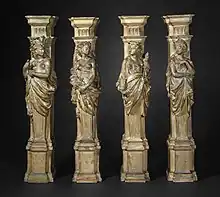 Four plaster columns, depicting women symbolically representing the continents of America, Africa, Europe, and Asia, respectively