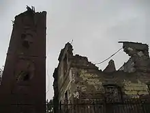 Damaged tower and destroyed building,  before renovation