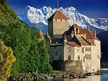 Image 40Château de Chillon, a castle on the north shore of Lake Geneva, against the backdrop of the Dents du Midi (from Alps)