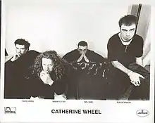 The band seated on a couch