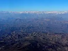 Wide view observatories from the air, including Cerro Pachón. In the distance are the Andes