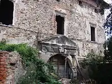 A stone building with a ruined gate