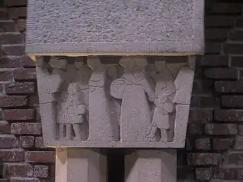 Column capital depicting pilgrims on way to shrine on Mount Saint-Odile, by Anne-Marie Roux-Colas