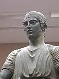 Detail of the statue's head, showing the inlaid eyes