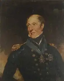 Half-length portrait of a man looking over his shoulder. His hair is sparse and balding, and he wears a dark blue jacket with epaulettes and gold buttons, with a blue sash collar around his neck, suspended from which is a medal.