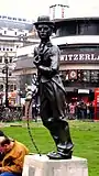 The statue's second location in Leicester Square, in 2008, with the Swiss Centre behind