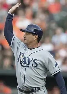 A baseball coach in gray and navy blue