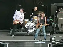 Carlos, Rick Nielsen, and Robin Zander of Cheap Trick performing in 2009