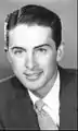 Actor Chet Allen wears "wet look" hair parted on the side, 1957.