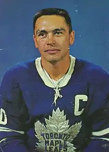 Armstrong poses for a studio shot in his Maple Leafs uniform. His sweater features a "C" patch denoting he was captain of his team.