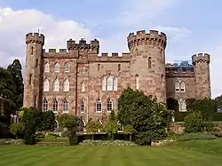 A country house with appearance of a castle with towers and battlements