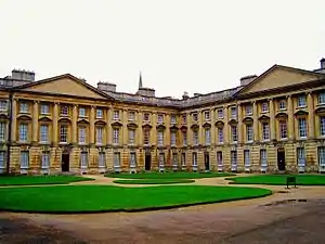 Exterior of large neo-classical building with extensive lawns in front of it