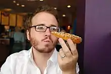 Author Christian Lander eating an everything bagel in Mar Vista, Los Angeles, California in 2008.