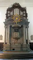 The altar topped by the pulpit and organ