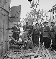 Churchill sits on a damaged chair from the Führerbunker in July 1945.