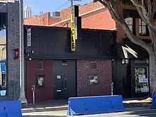 A brick building with a yellow marquee sign that says "Circle" in vertical letters.