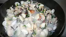 Clams simmering in a white wine sauce