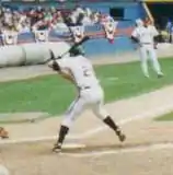 Jim Thome batting left-handed in a game in 1993; he is amidst his stride forward, and is about to swing.