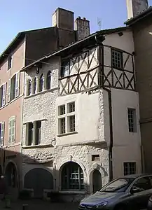 Houses in Cluny, France, one with half-timbering and render.