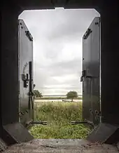 View from within a casemate showing the river, trees and grassy ground