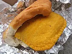 A Jamaican patty wrapped in coco bread.