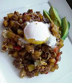 A coddled egg atop hash