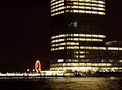 The clock at night, with the Goldman Sachs Tower in the foreground