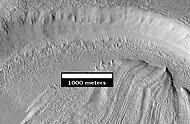 Concentric Crater Fill Close-up of near the top of previous image, as seen by HiRISE.  The surface debris covers water ice.