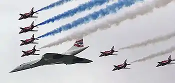 Image 6Concorde (and the Red Arrows with their trail of red, white and blue smoke) mark the Queen's Golden Jubilee. With its slender delta wings Concorde won the public vote for best British design. (from Culture of the United Kingdom)