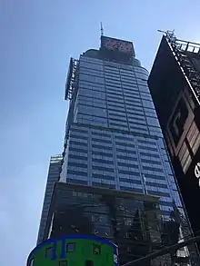 The building's glass wall as seen from ground level