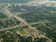 An aerial photo of a 3-legged highway interchange in an urban area