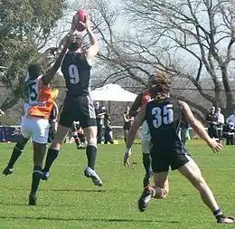 New Zealand's captain Andrew Congalton takes a strong mark in front of an Indian opponent