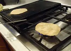 Chapati cooked on open-flame after being cooked on tava