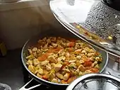 Cooking jasha maru, a traditional dish consisting of minced chicken, tomatoes, and other ingredients