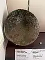 Display at the Louvre (AO 4702), from Sparta. Described as "Phoenician bowl: This bowl may be compared to the Phoenician silver bowls"