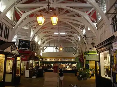 Inside the Covered Market, Oxford, England. Curved roof trusses imitate the form of a stone arcade.